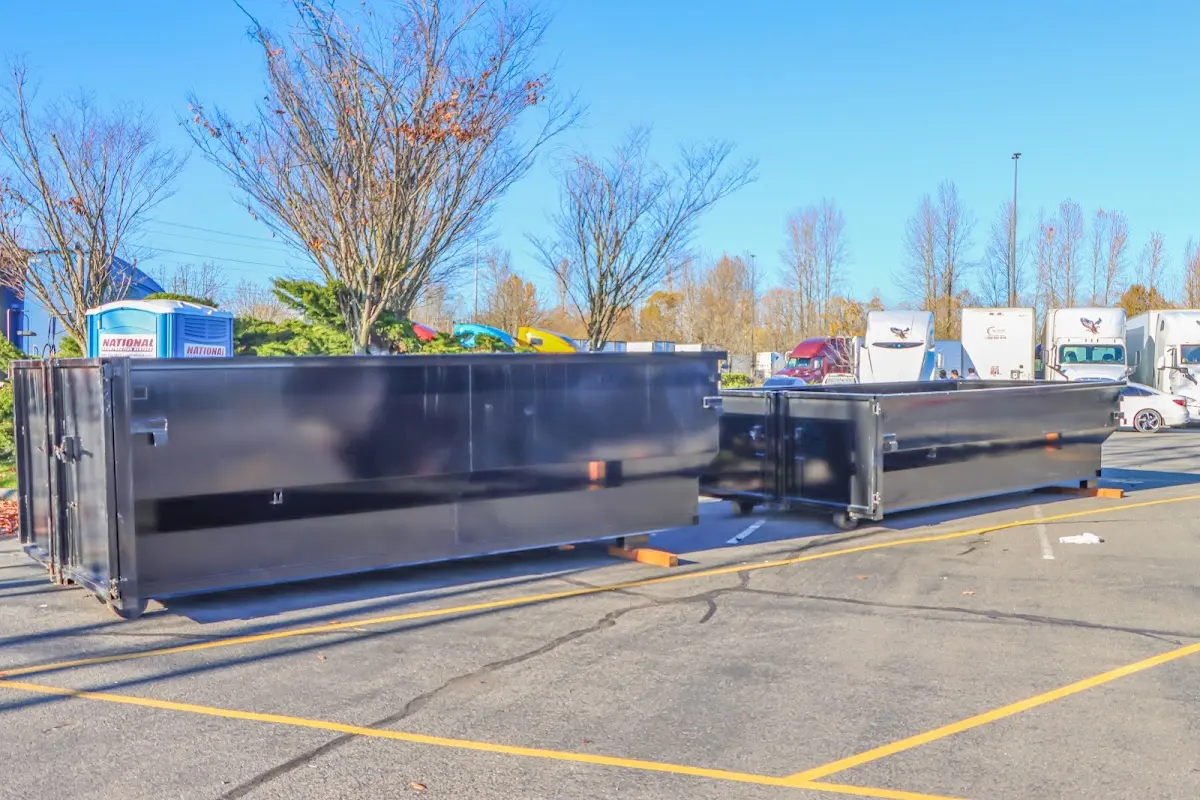 Professional dumpster rental service with roll-off container on residential driveway in Grandwood Park